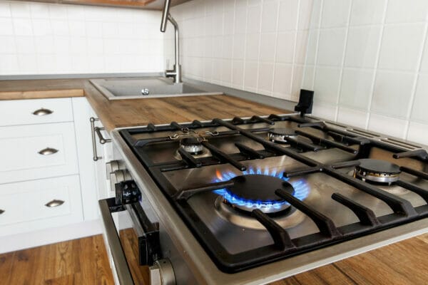 burning gas from kitchen stove on background of stylish kitchen