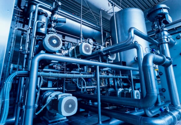 Modern interior of a brewery. Barrels and pipes. Factory interior.