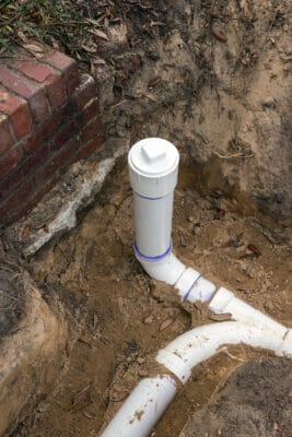 New PVC Sewer Pipe Line Installed in Trench