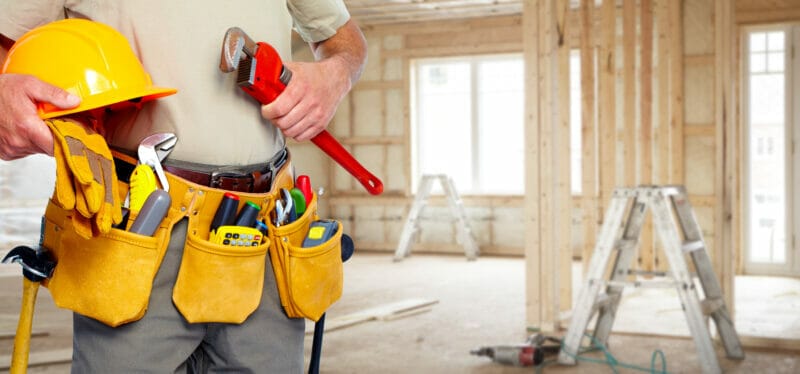 Builder handyman with construction tools.