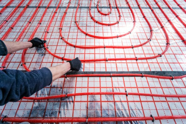 Pipefitter install system of underfloor heating system at home