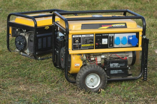 yellow petrol portable generator on wheels, close-up, alternator